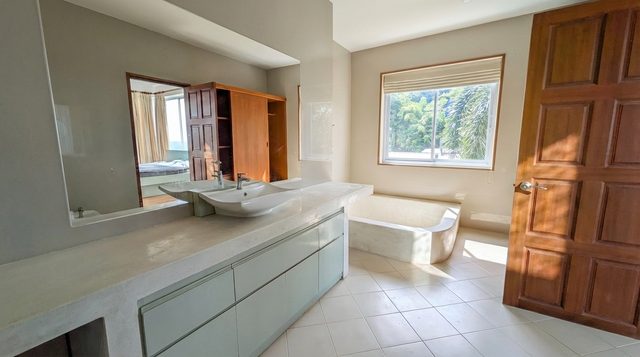 Bright bathroom with two sinks and a wide mirror