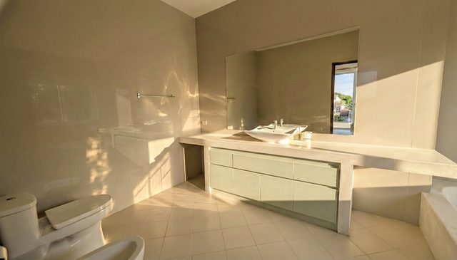 Bright bathroom with a wide vanity and mirror