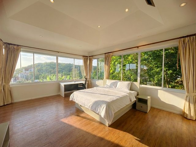 Spacious double bedroom with warm timber details