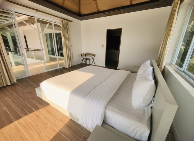 Twin bedroom with panoramic windows and a sea view