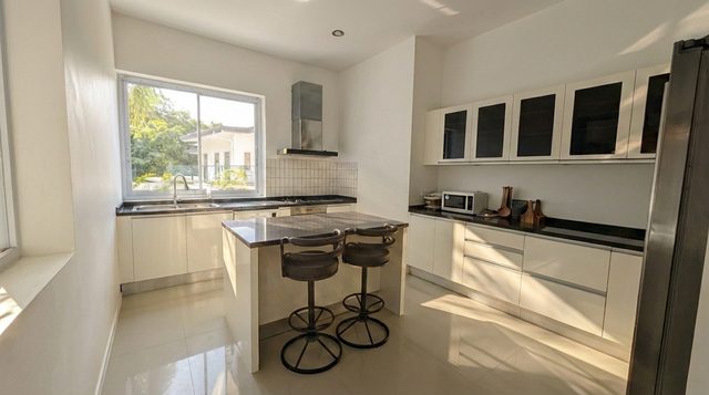 Fully equipped kitchen shown in full with a central island