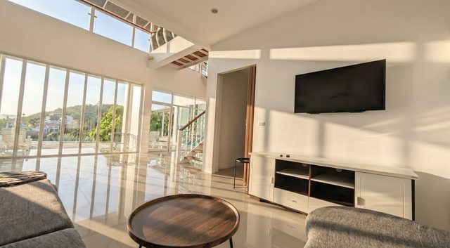 Media lounge with comfortable seating and panoramic glazing